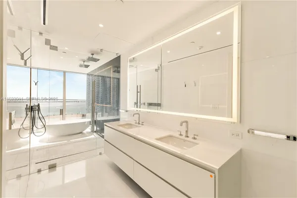 a spacious bathroom with a double vanity sink and a mirror