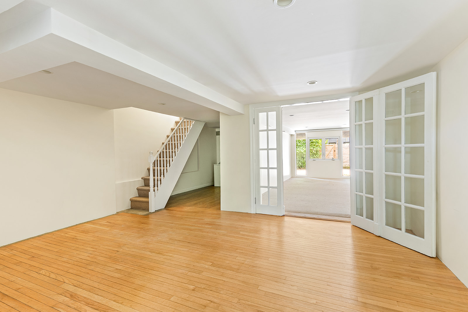 22 Sharon Street Brooklyn, NY 11211 - Photo 7 of 10 a view of an empty room with wooden floor and a window