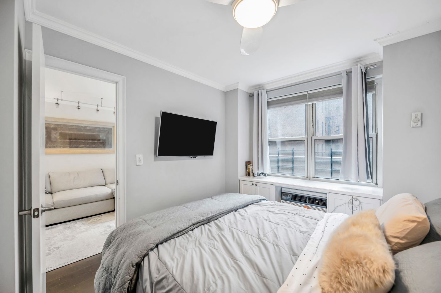 333 East 79th Street, Unit 2R Manhattan, NY 10075 - Photo 7 of 13 a bedroom with a bed and a flat screen tv