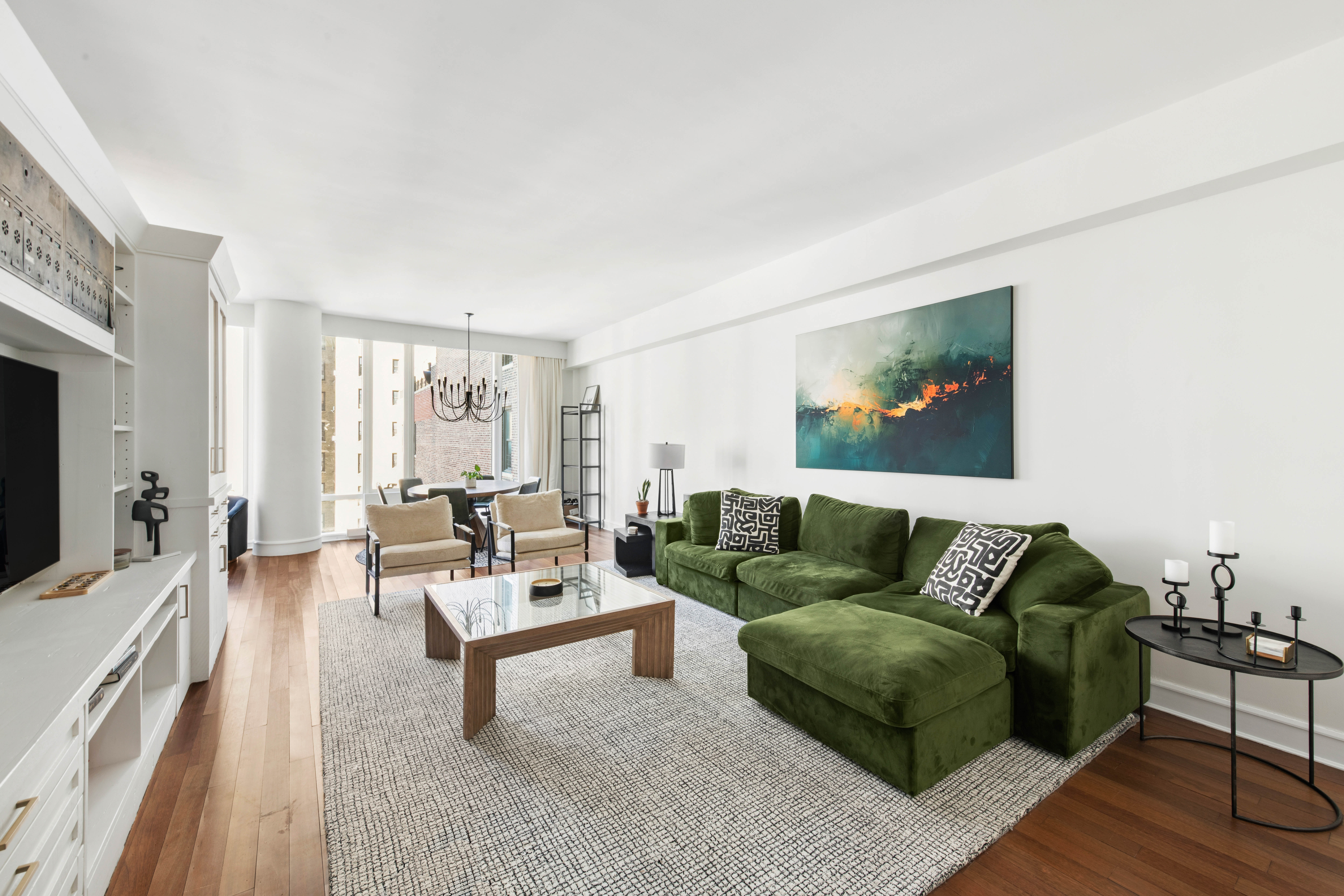 245 West 99th Street, Unit 8A Manhattan, NY 10025 - Photo 3 of 12 a living room with furniture and a flat screen tv