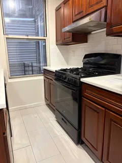 a kitchen with granite countertop a stove and a cabinets