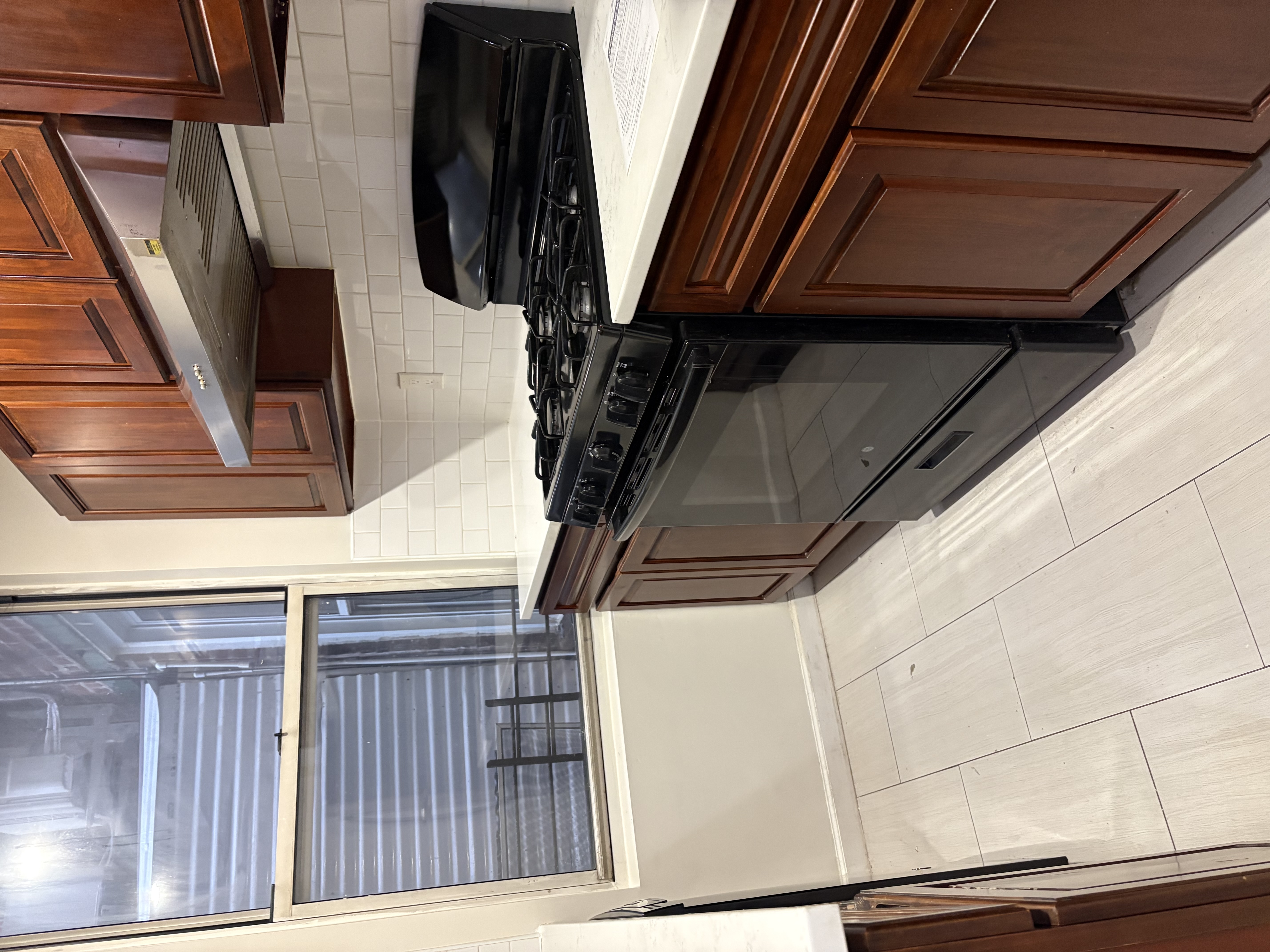8703 5th Avenue, Unit 2F Brooklyn, NY 11209 - Photo 2 of 9 a kitchen with granite countertop a stove and a cabinets