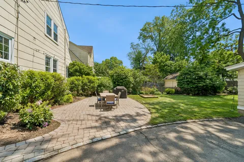 a view of backyard with outdoor seating and green space
