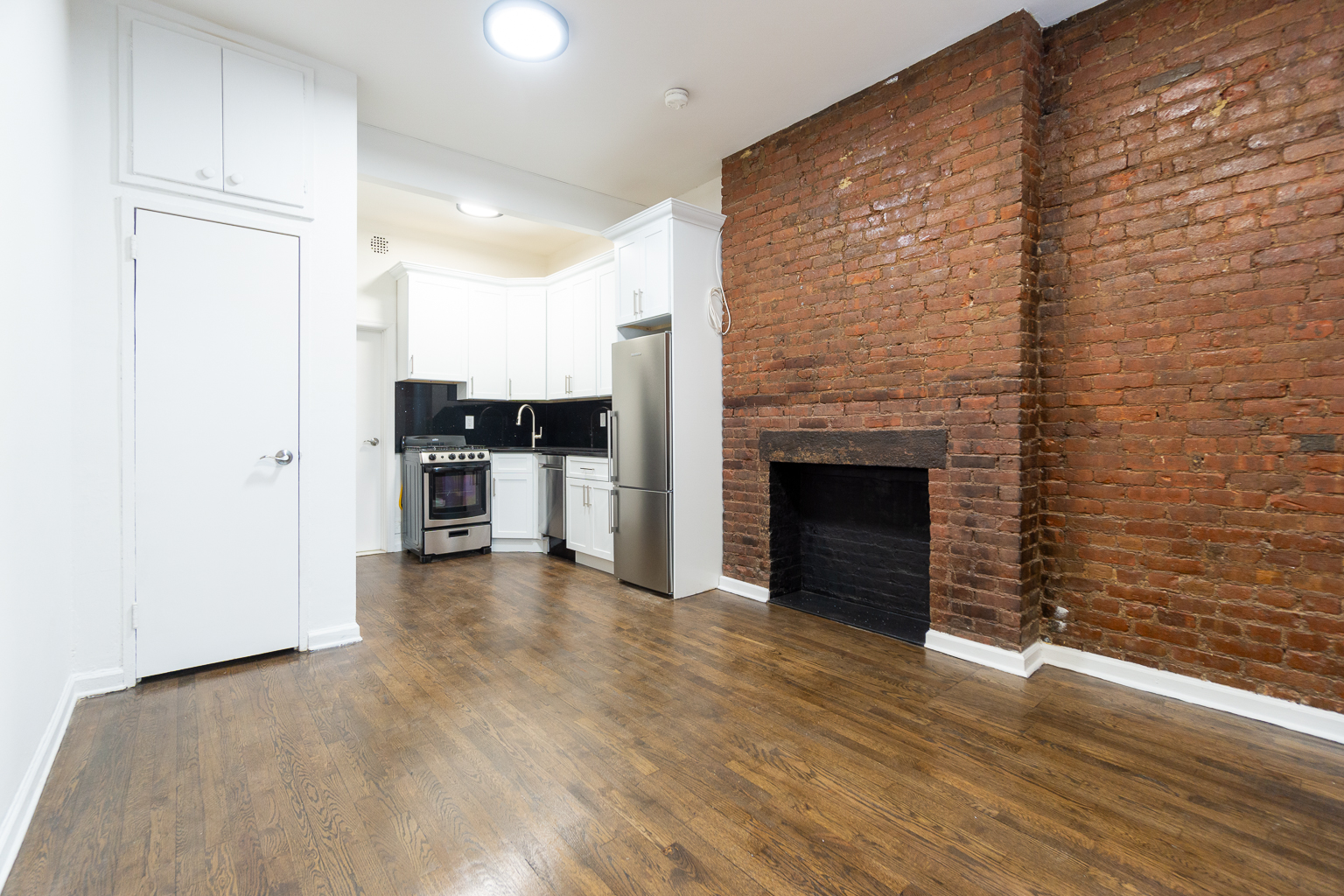 339 East 6th Street, Unit B Manhattan, NY 10003 - Photo 12 of 22 a view of a kitchen with a sink and a fireplace