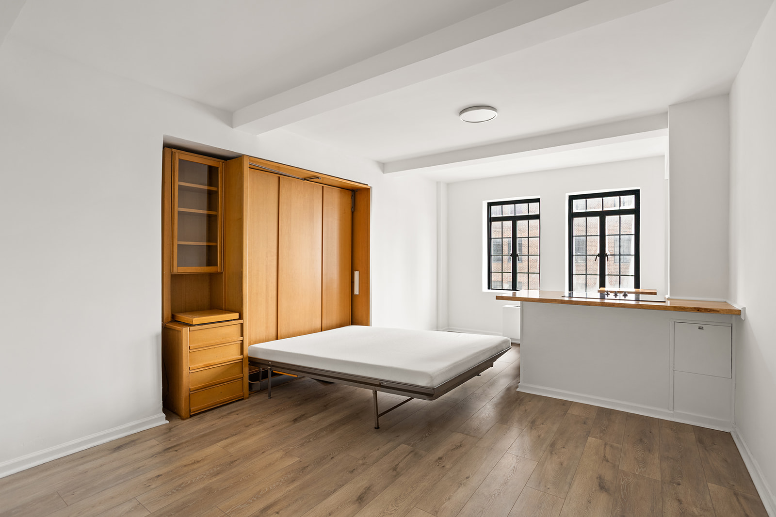 5 Tudor City Place, Unit 602 Manhattan, NY 10017 - Photo 5 of 20 a living room with hardwood floor and a window
