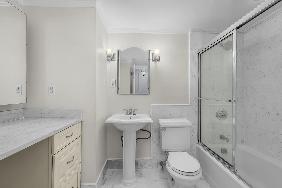 106 Central Park South, Unit 7L Manhattan, NY 10019 - Photo 7 of 10 a bathroom with a sink toilet and shower