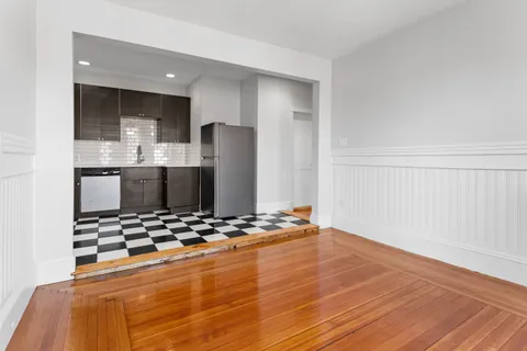 a kitchen with stainless steel appliances kitchen island granite countertop a refrigerator and a stove top oven