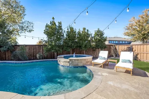 a view of a backyard with sitting area