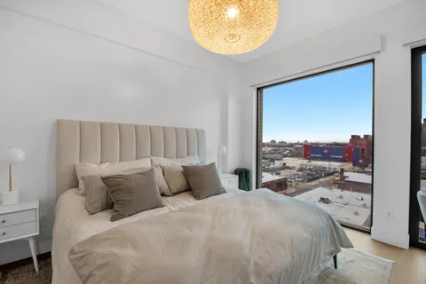 a bedroom with a bed and a painting on the wall