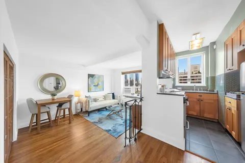 a living room with furniture a fireplace and wooden floor