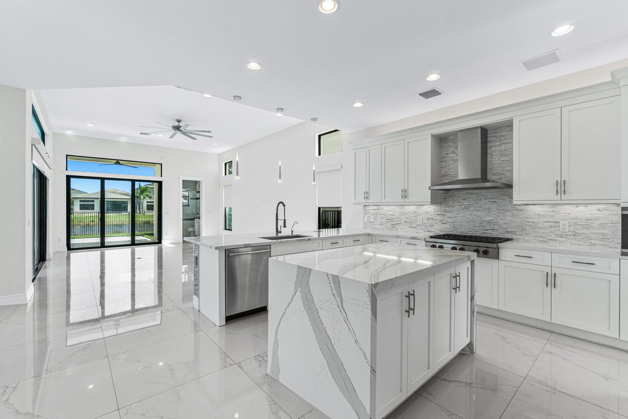 17352 Rosella Road Boca Raton, FL 33496 - Photo 10 of 41 a kitchen with a stove top oven sink and cabinets