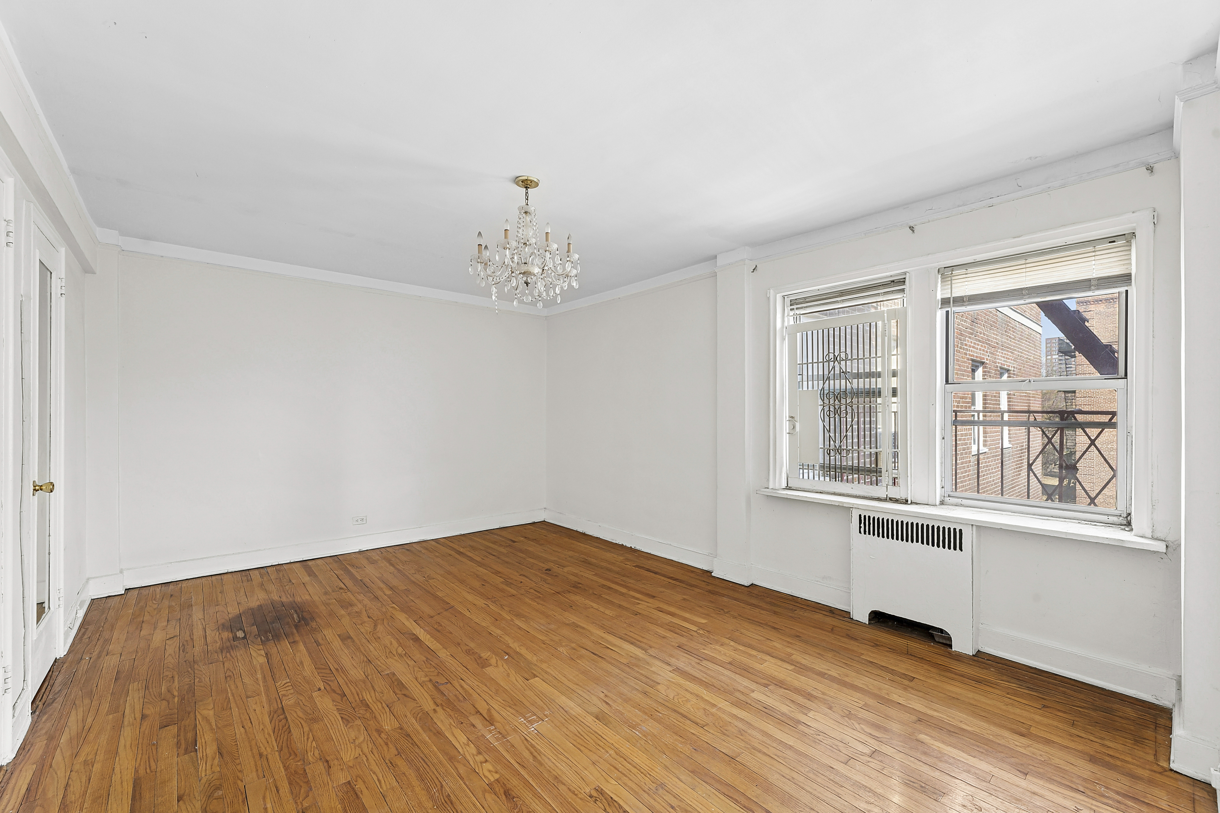 5444 Arlington Avenue, Unit G51 Bronx, NY 10471 - Photo 7 of 16 a view of an empty room with a window and wooden floor