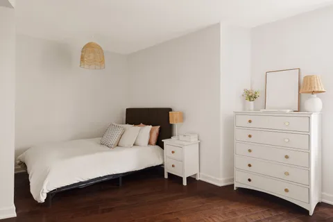 a bedroom with a bed and a dresser