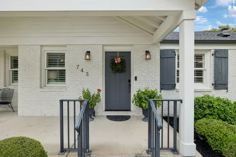 front view of a house with potted plants