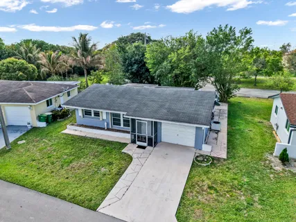 aerial view of a house with a yard