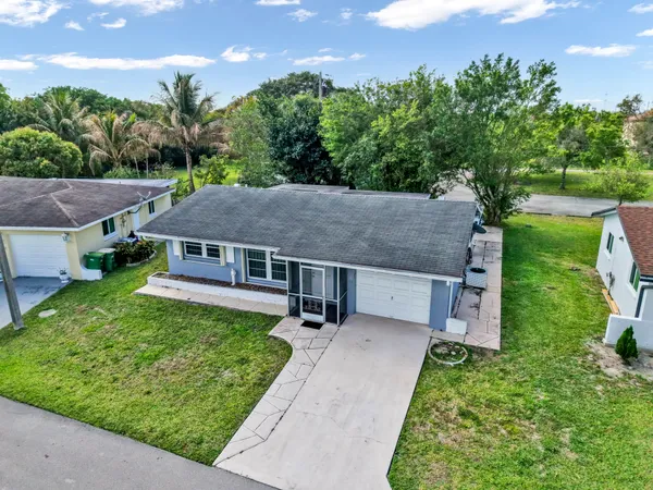 aerial view of a house with a yard
