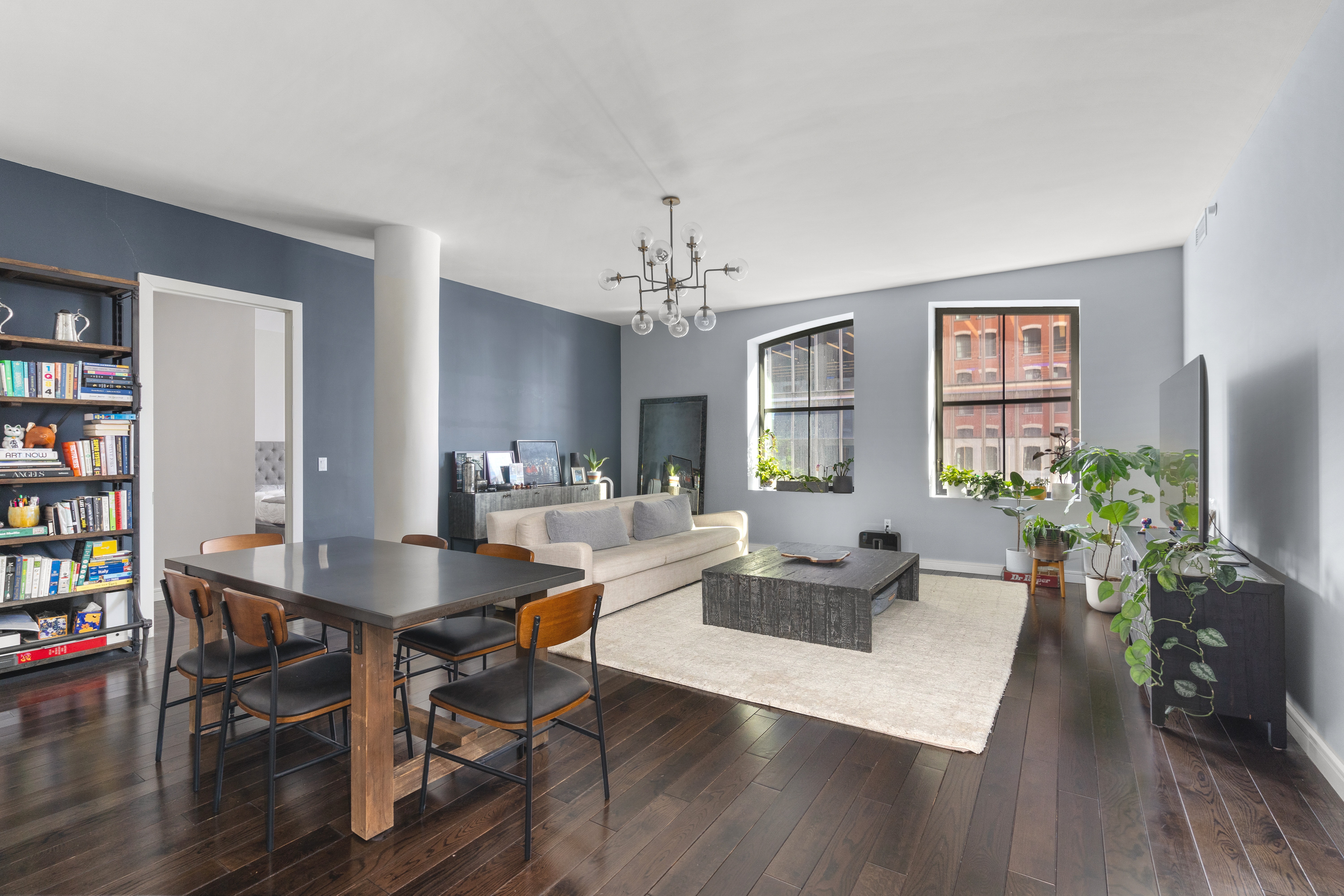 250 West Street, Unit 3F Manhattan, NY 10013 - Photo 2 of 11 a living room with furniture a chandelier and wooden floor