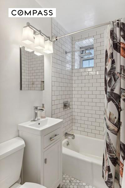 43 East 10th Street, Unit 5J Manhattan, NY 10003 - Photo 4 of 7 a bathroom with a sink a toilet and shower