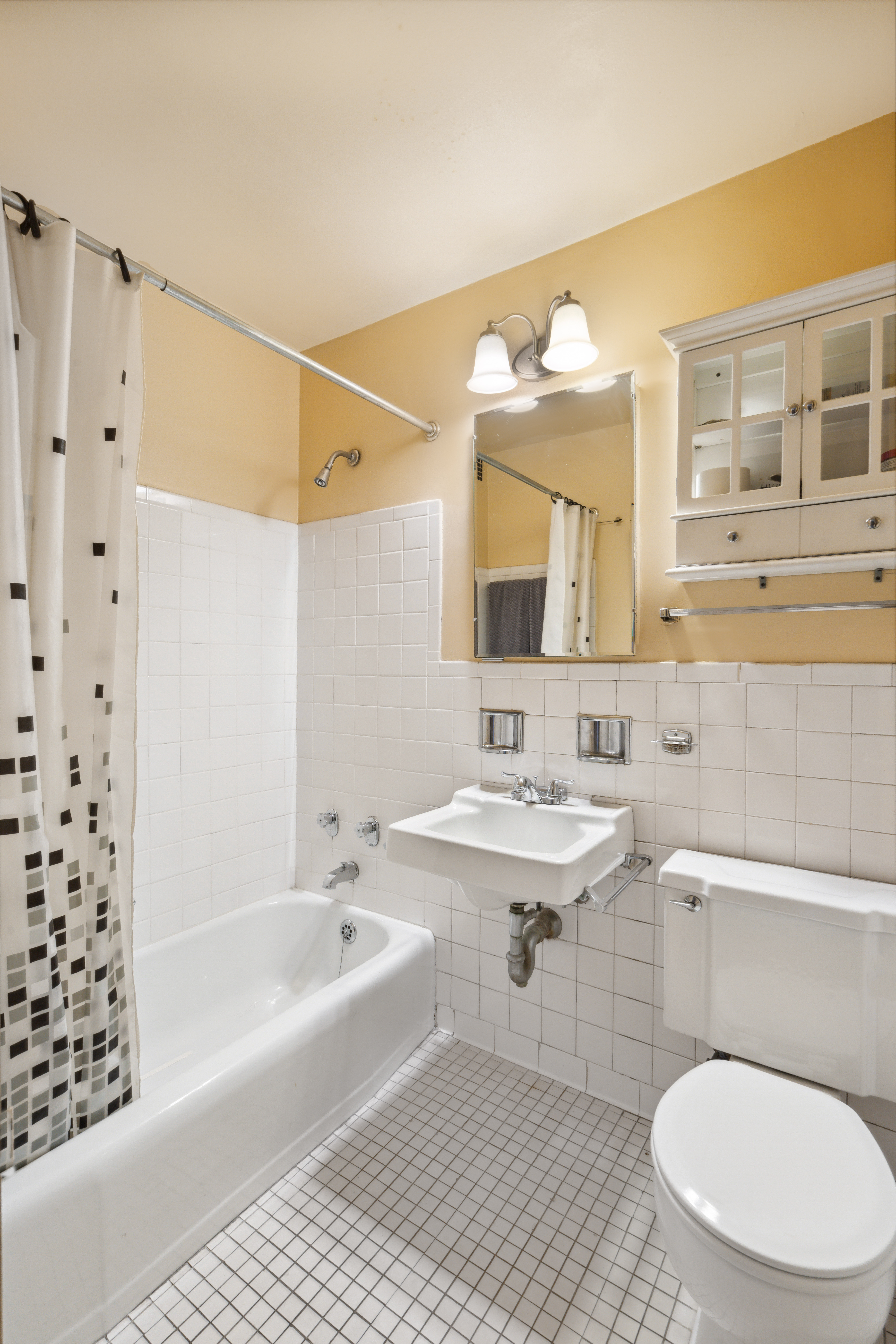 330 East 33rd Street, Unit 7C Manhattan, NY 10016 - Photo 6 of 18 a bathroom with a sink a toilet and shower