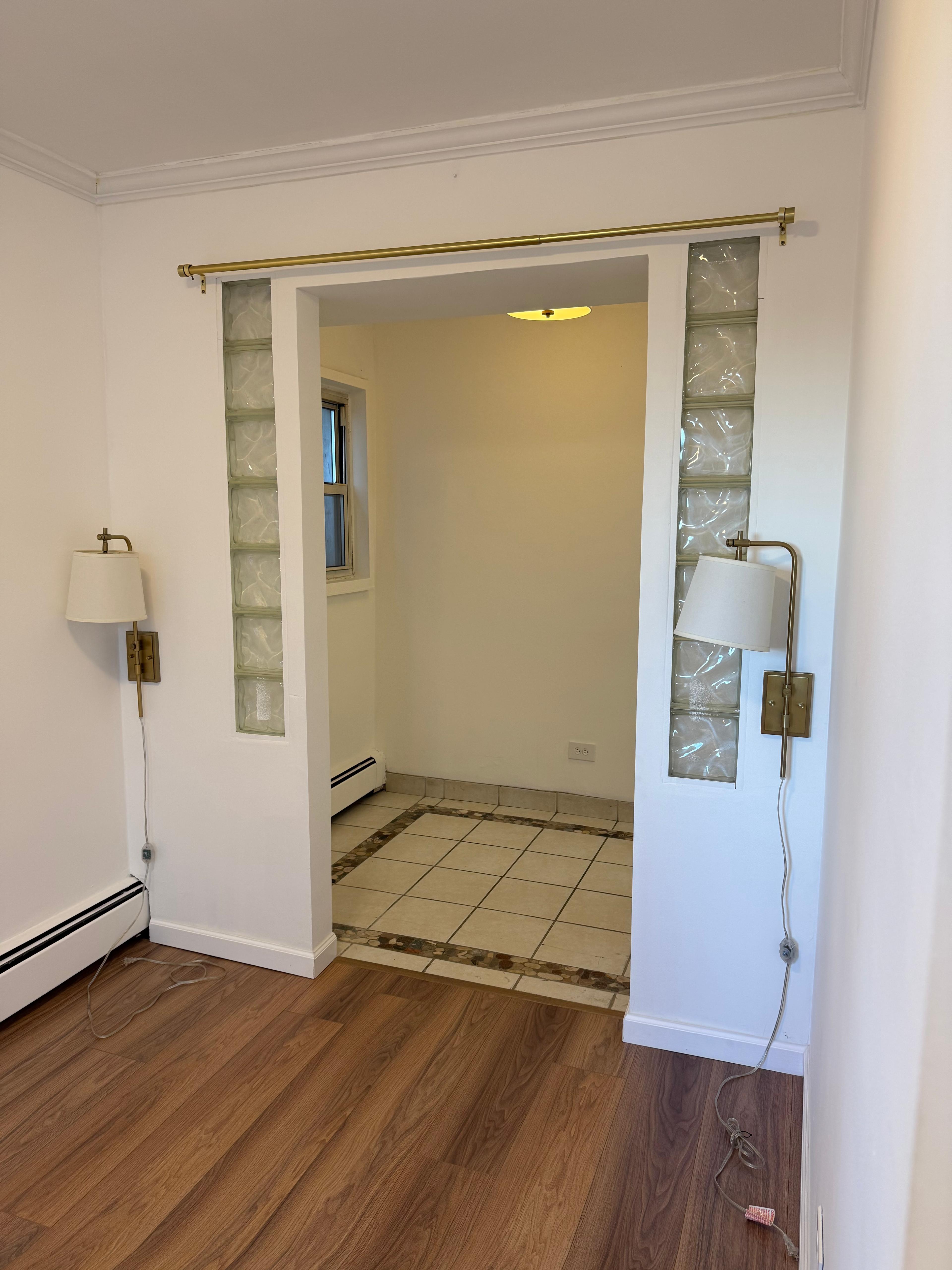 40 Sutton Place, Unit 7A Manhattan, NY 10022 - Photo 8 of 11 an empty room with wooden floor and windows