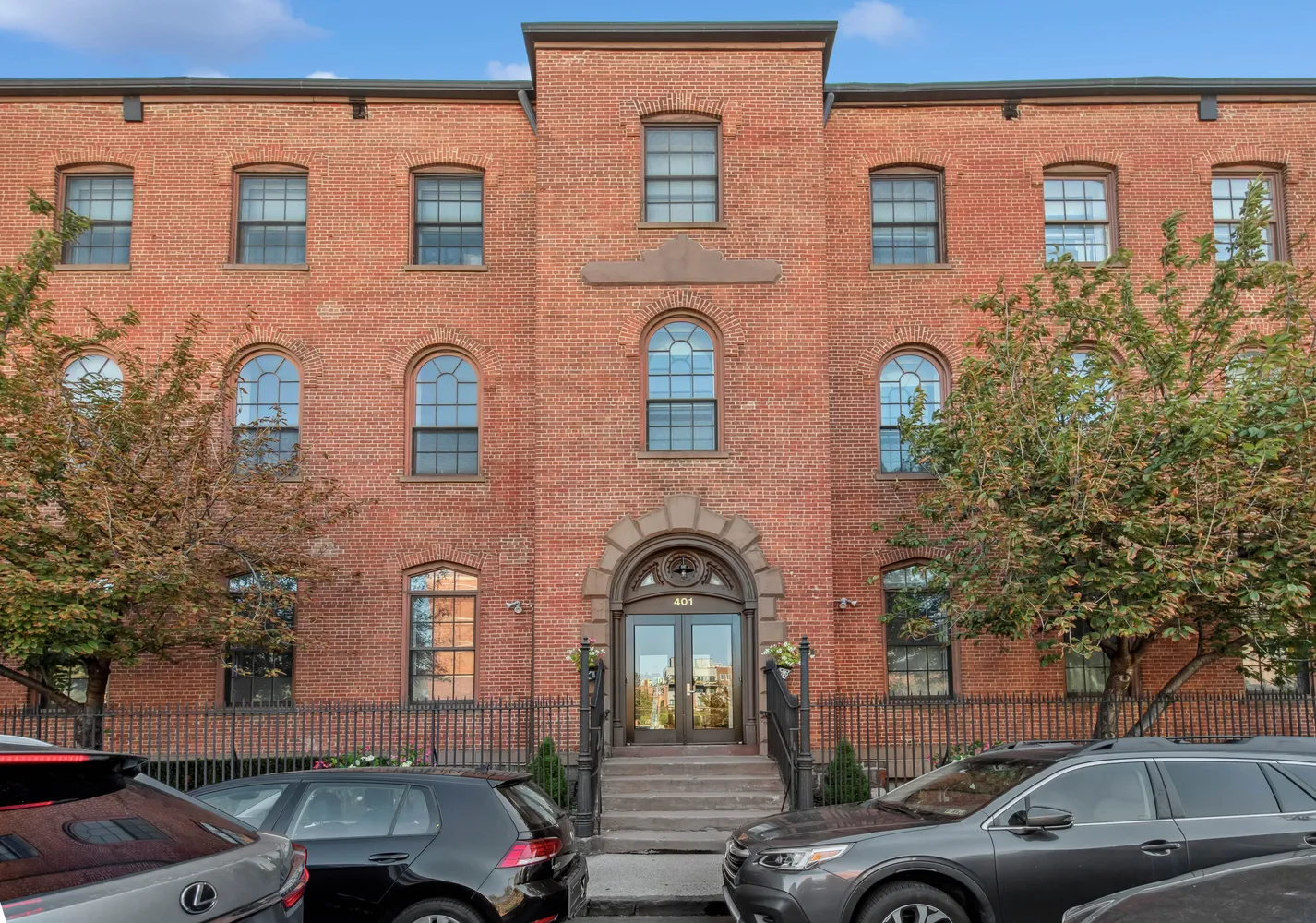 a front view of a building with parking space and parking space
