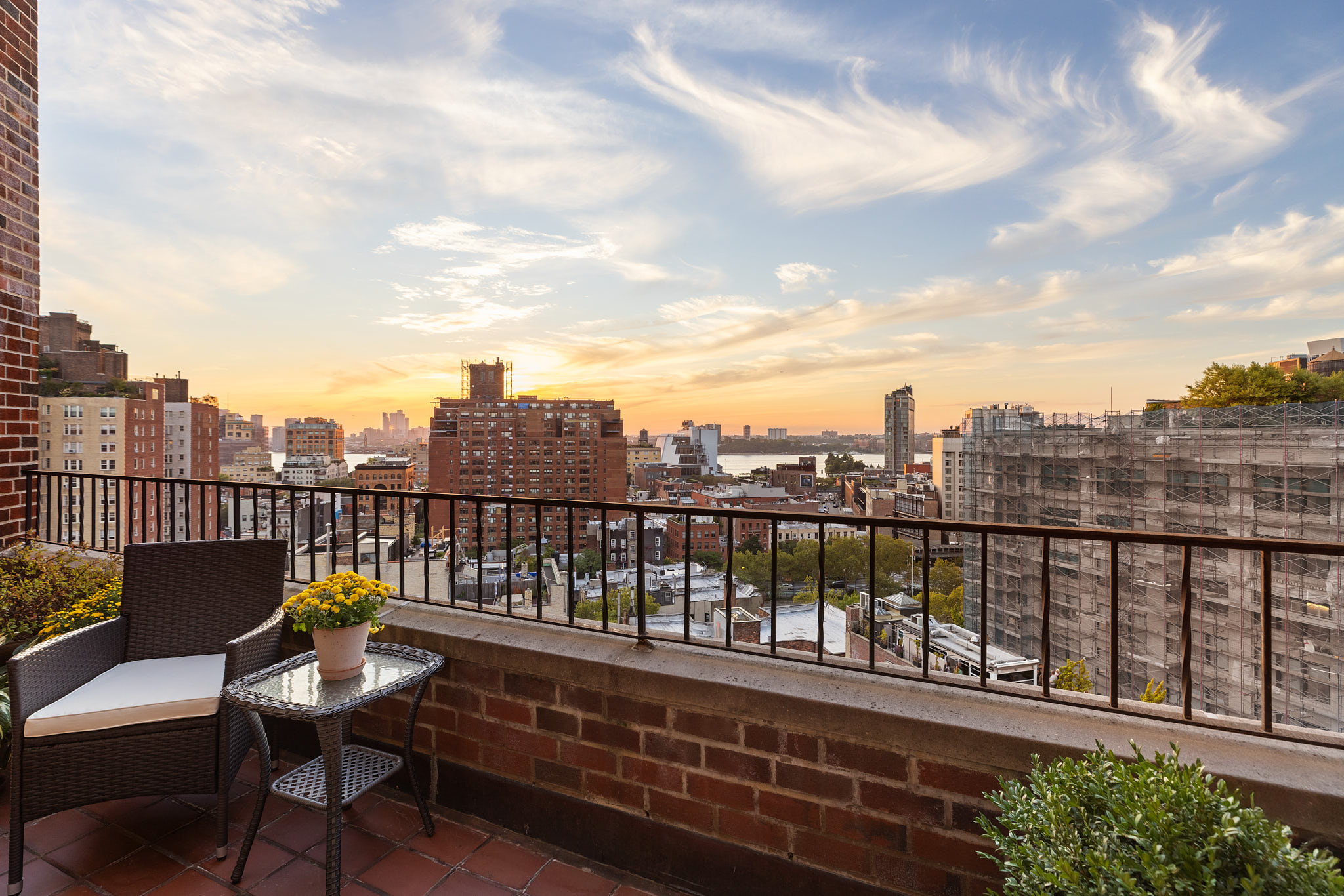 31 Jane Street, Unit 16A Manhattan, NY 10014 - Photo 9 of 17 a view of a balcony with wooden chairs and wooden fence