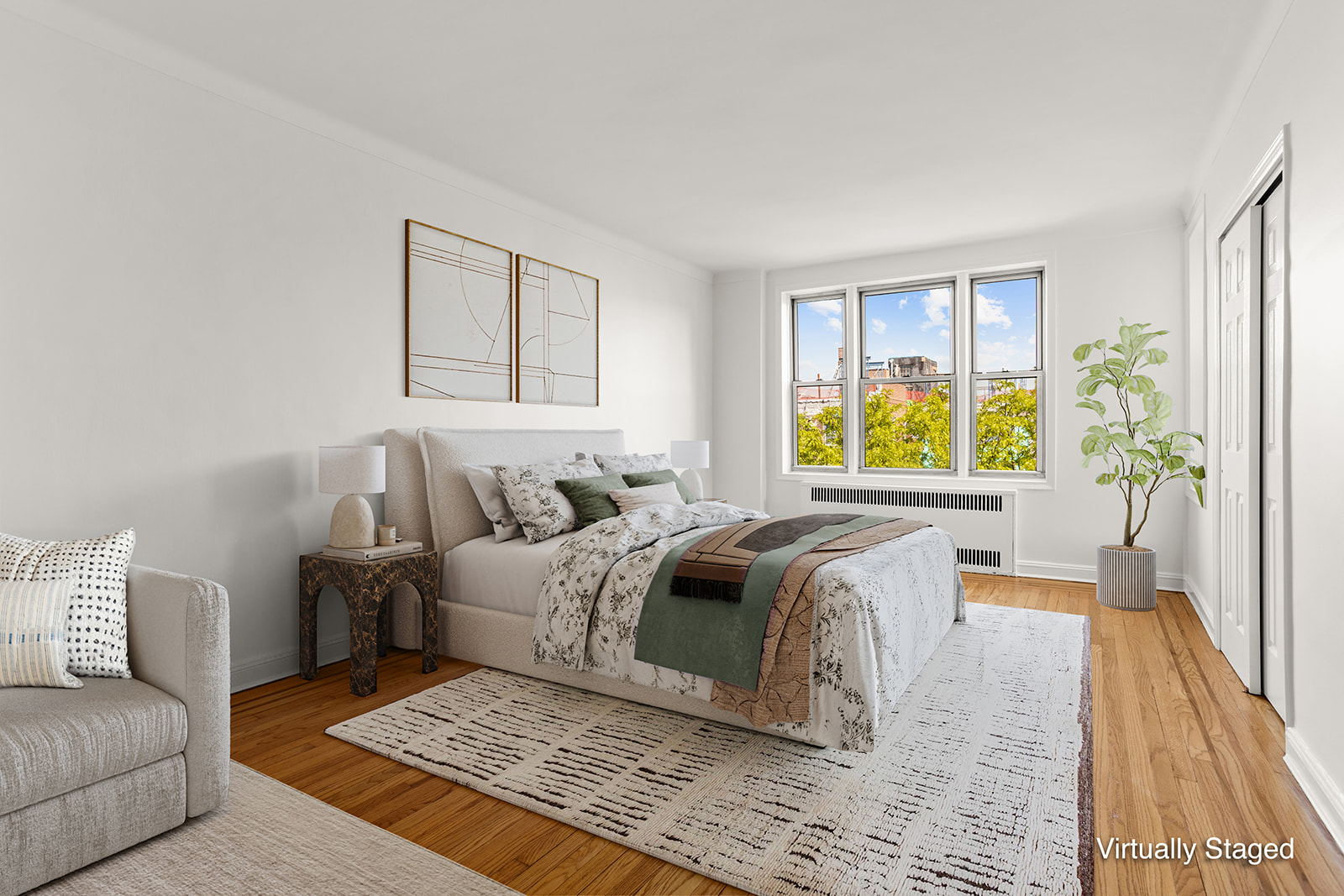 76-12 35th Avenue, Unit 6N Queens, NY 11372 - Photo 1 of 14 a living room with a bed furniture and a couch