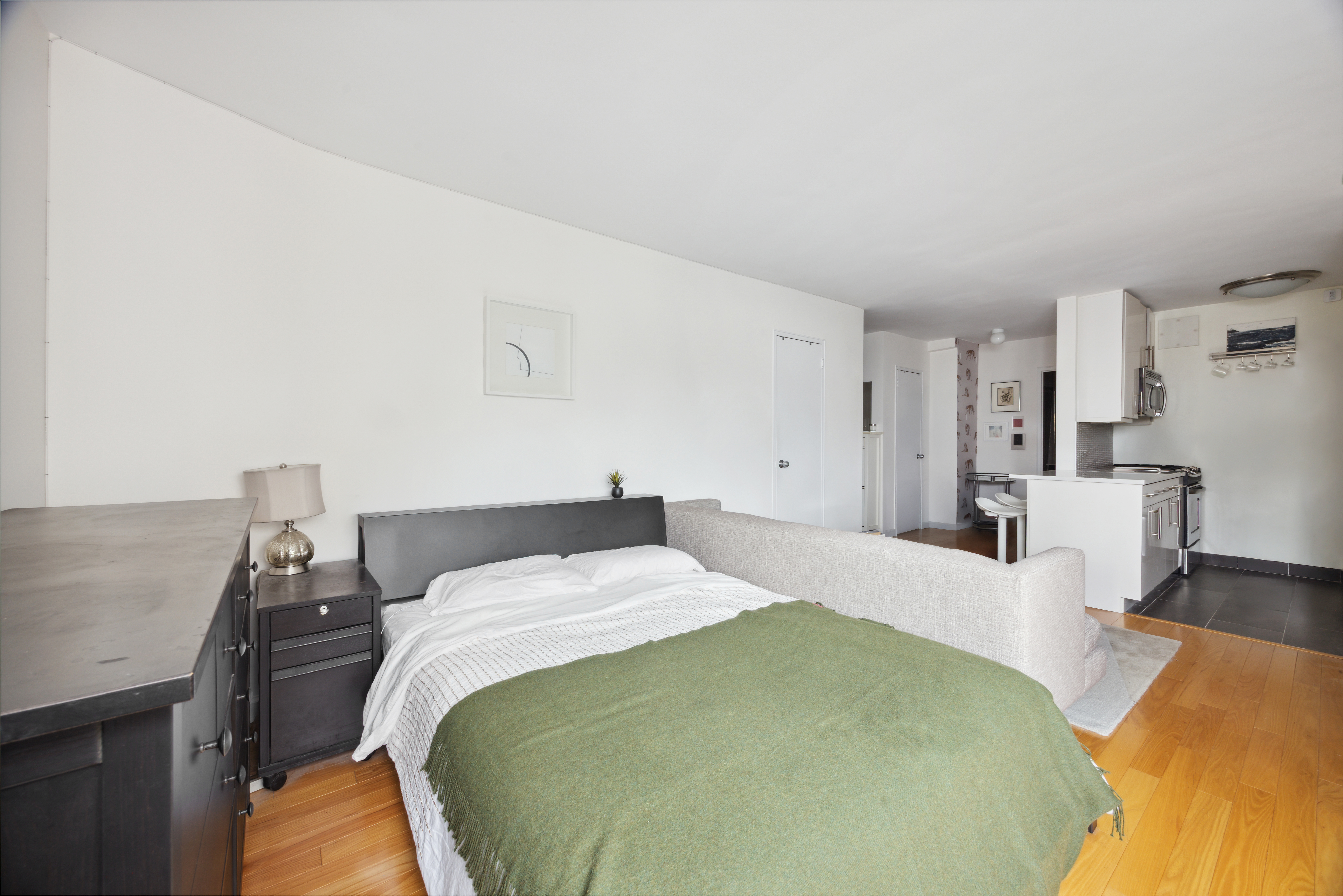 240 East 76th Street, Unit 14A Manhattan, NY 10021 - Photo 5 of 8 a bed room with a bed and a chair