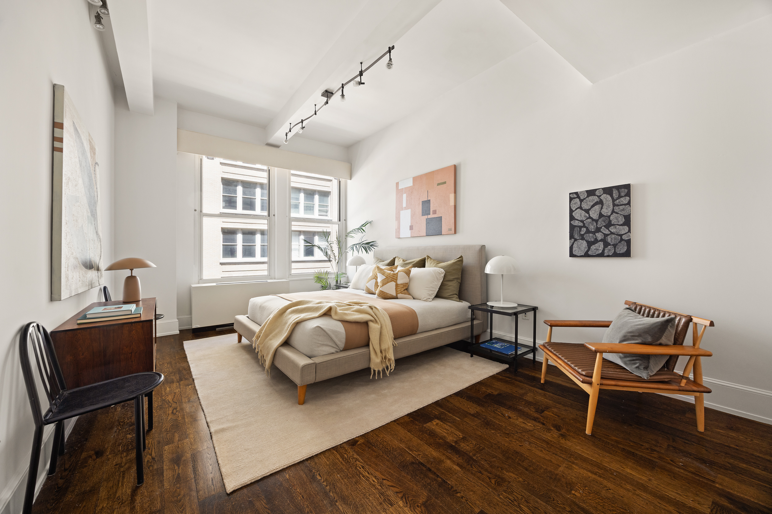 260 Park Avenue South, Unit 9G Manhattan, NY 10010 - Photo 7 of 17 a spacious bedroom with a bed and a desk