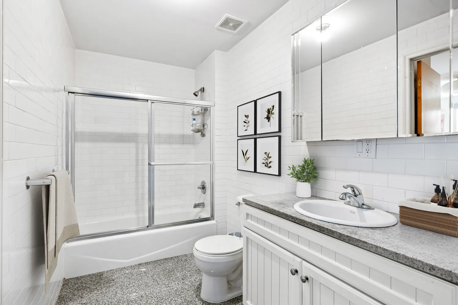 a bathroom with a granite countertop sink toilet and shower