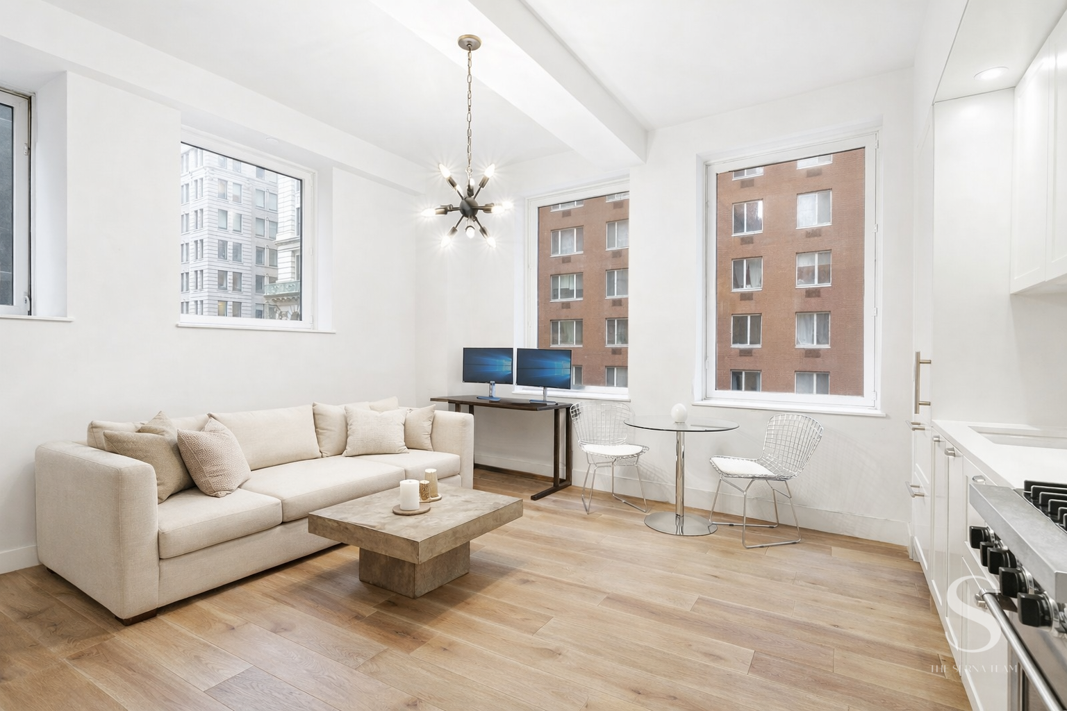 93 Worth Street, Unit 302 Manhattan, NY 10013 - Photo 1 of 10 a living room with furniture and view of kitchen