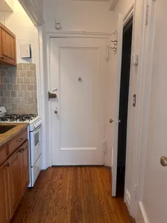 a view of walk in closet with hardwood floor
