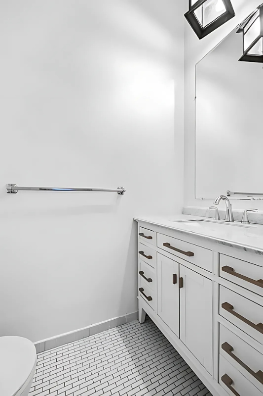 448 West 37th Street, Unit 6H Manhattan, NY 10018 - Photo 7 of 9 a bathroom with a sink a toilet and a mirror