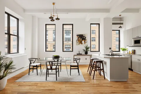 a view of a a dining room with furniture window and wooden floor