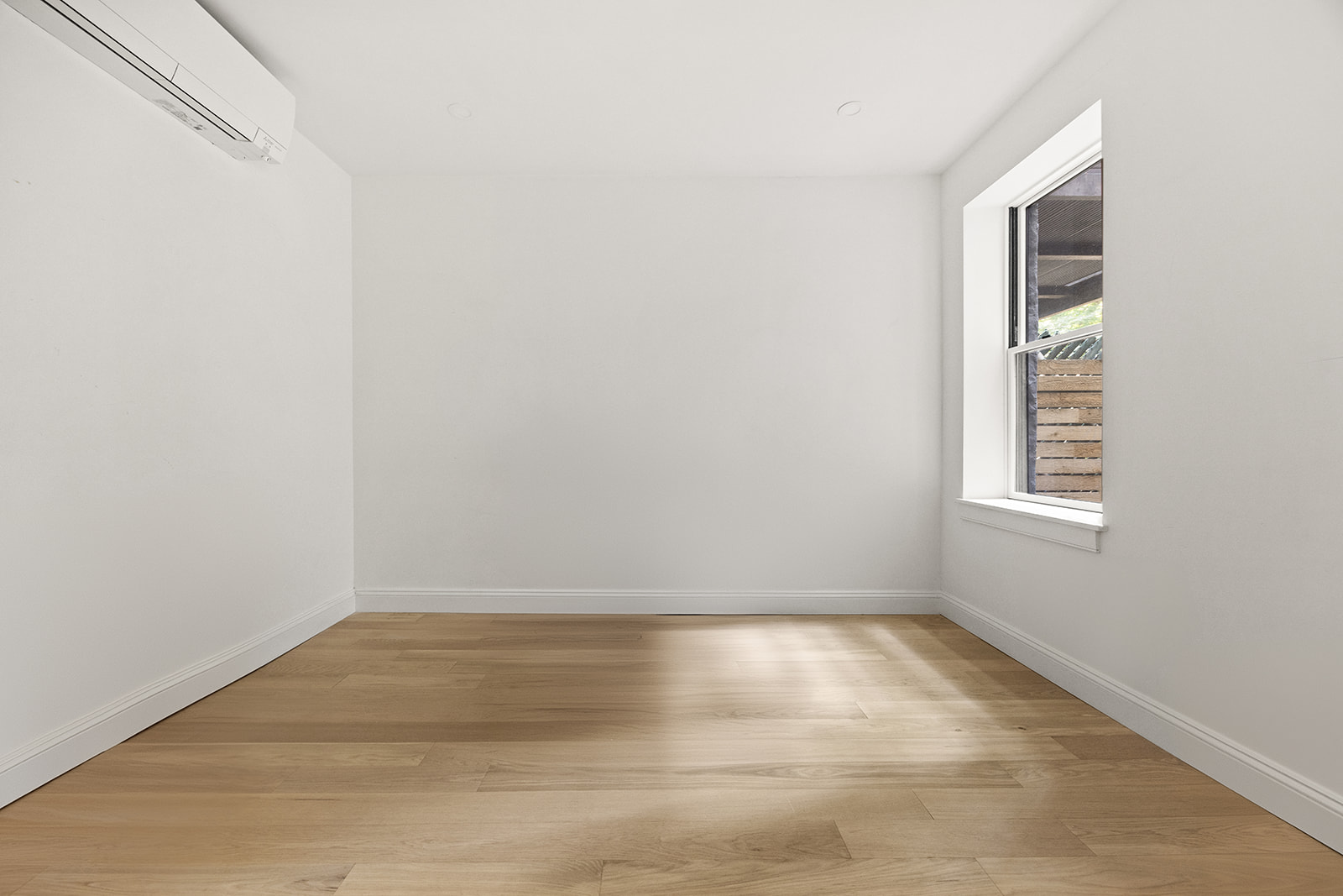 84 6th Avenue, Unit 1 Brooklyn, NY 11217 - Photo 11 of 22 a view of empty room with wooden floor and fan