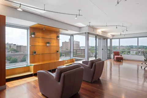 a kitchen with stainless steel appliances kitchen island granite countertop a sink and a refrigerator