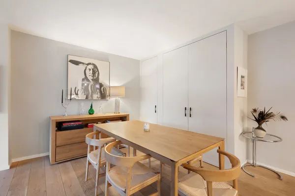 a view of a dining room with furniture and wooden floor