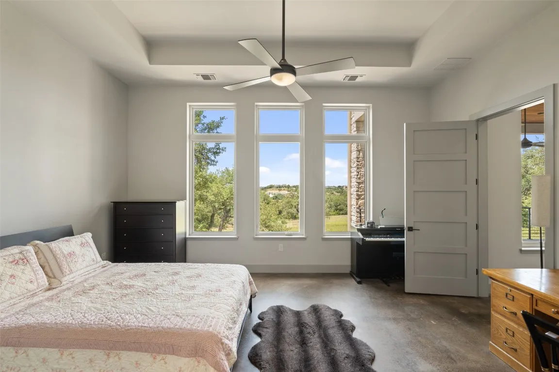 a spacious bedroom with a bed and a window