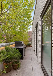 a view of a chairs and table in the balcony