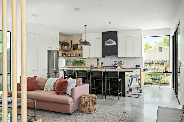 a living room with furniture a fireplace and a large window