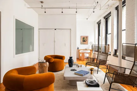a living room with furniture and a rug