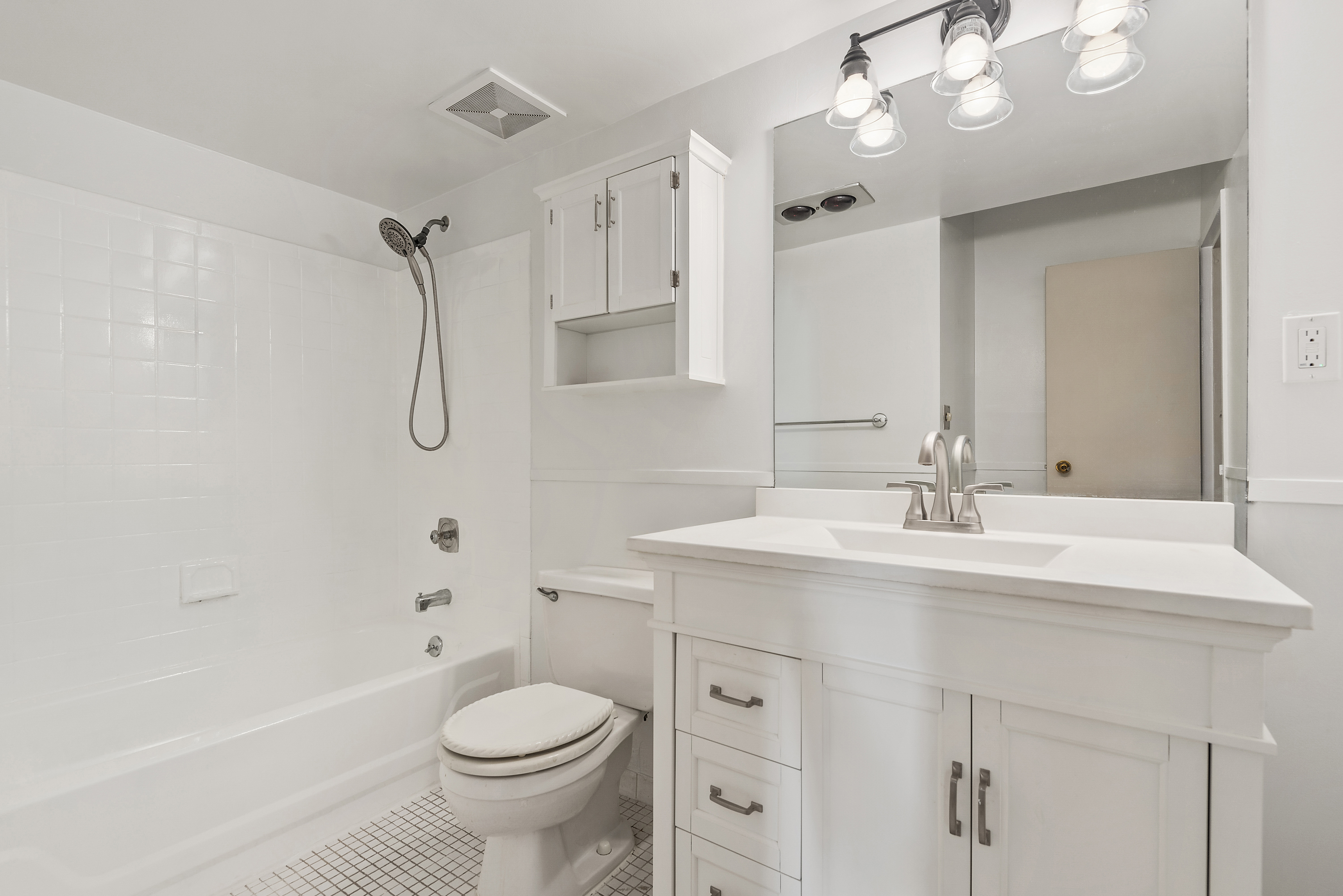 9951 Shore Road, Unit 1B Brooklyn, NY 11209 - Photo 8 of 9 a bathroom with a sink a toilet and a mirror