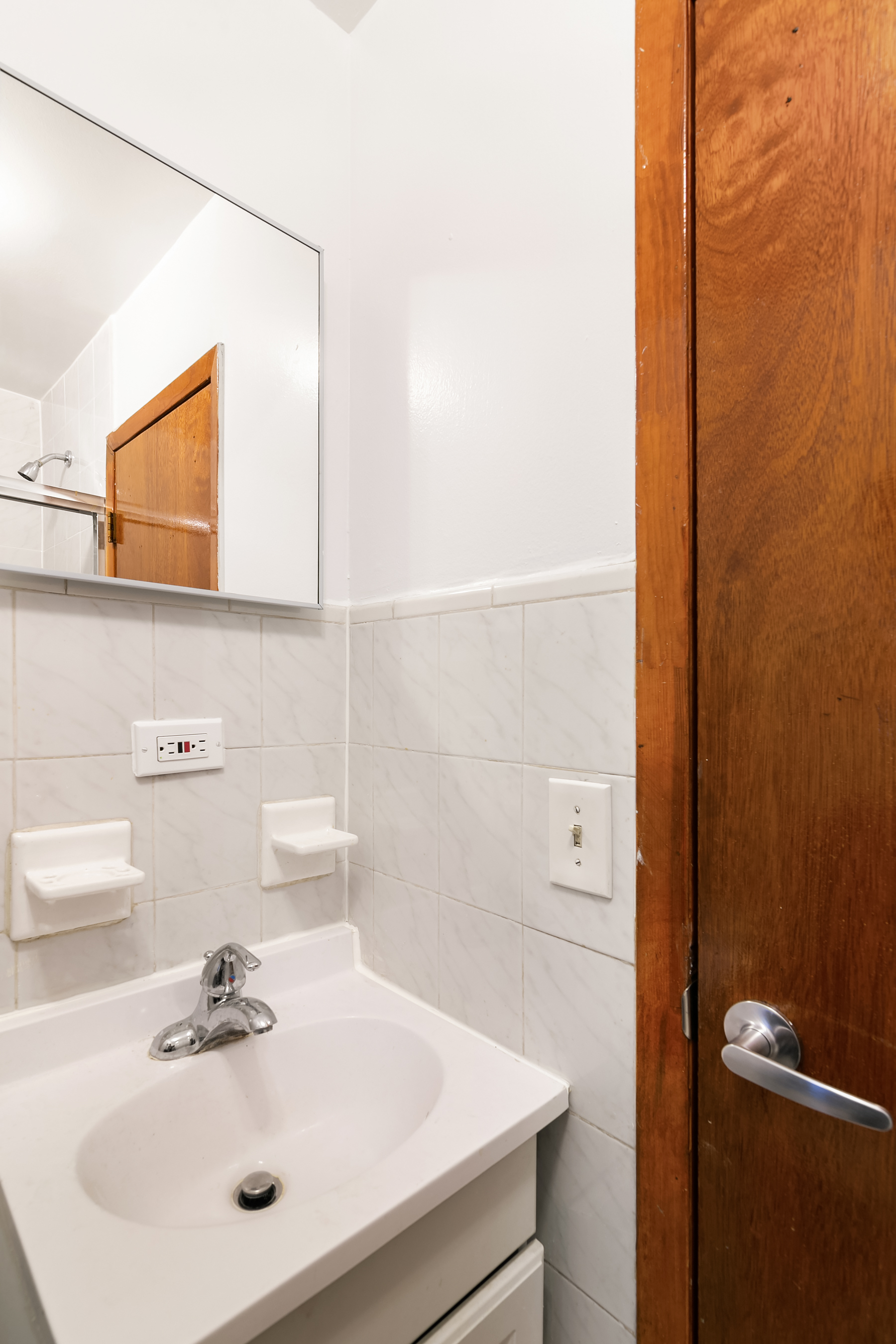 49 Perry Street, Unit 2E Manhattan, NY 10014 - Photo 3 of 3 a bathroom with a sink and a mirror