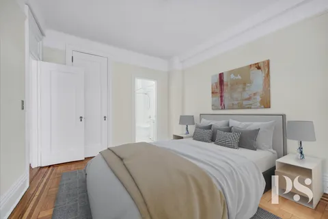 a bedroom with a bed and a painting on the wall