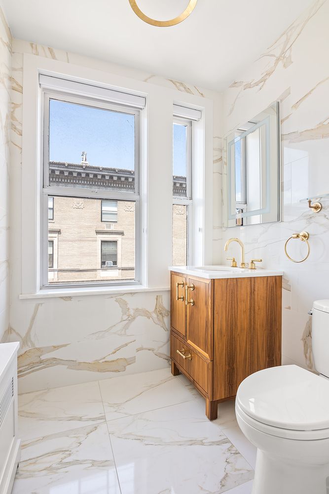240 West End Avenue, Unit PH Manhattan, NY 10023 - Photo 21 of 25 a bathroom with a sink a toilet and mirror