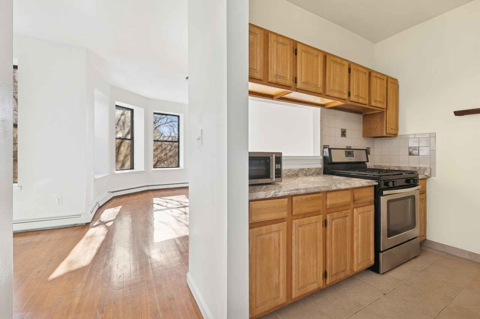 859 Riverside Drive, Unit 3 Manhattan, NY 10032 - Photo 3 of 7 a kitchen with stainless steel appliances granite countertop a stove and a sink