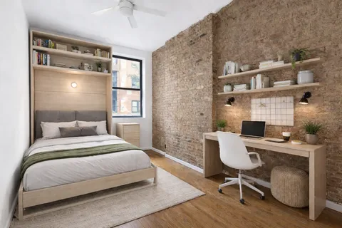 a bedroom with a bed and a desk