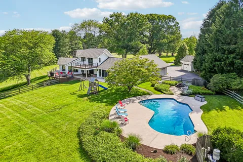 a view of a swimming pool with a yard