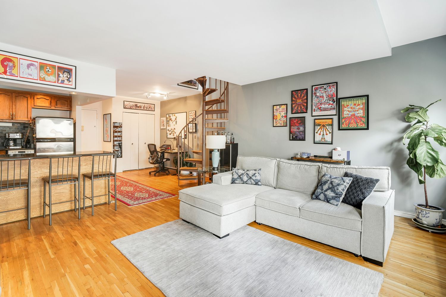 a living room with furniture and a floor to ceiling window
