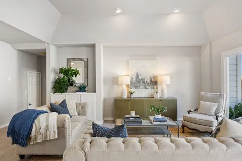 a living room with furniture and a potted plant